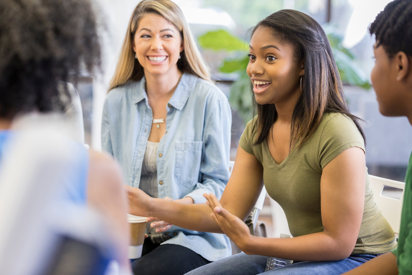 Vulnerable teen talks during group therapy session